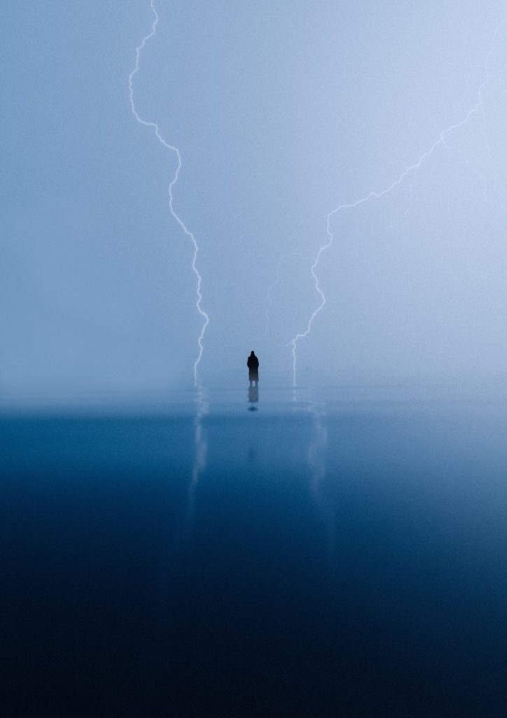 A person standing in the middle of a body of water